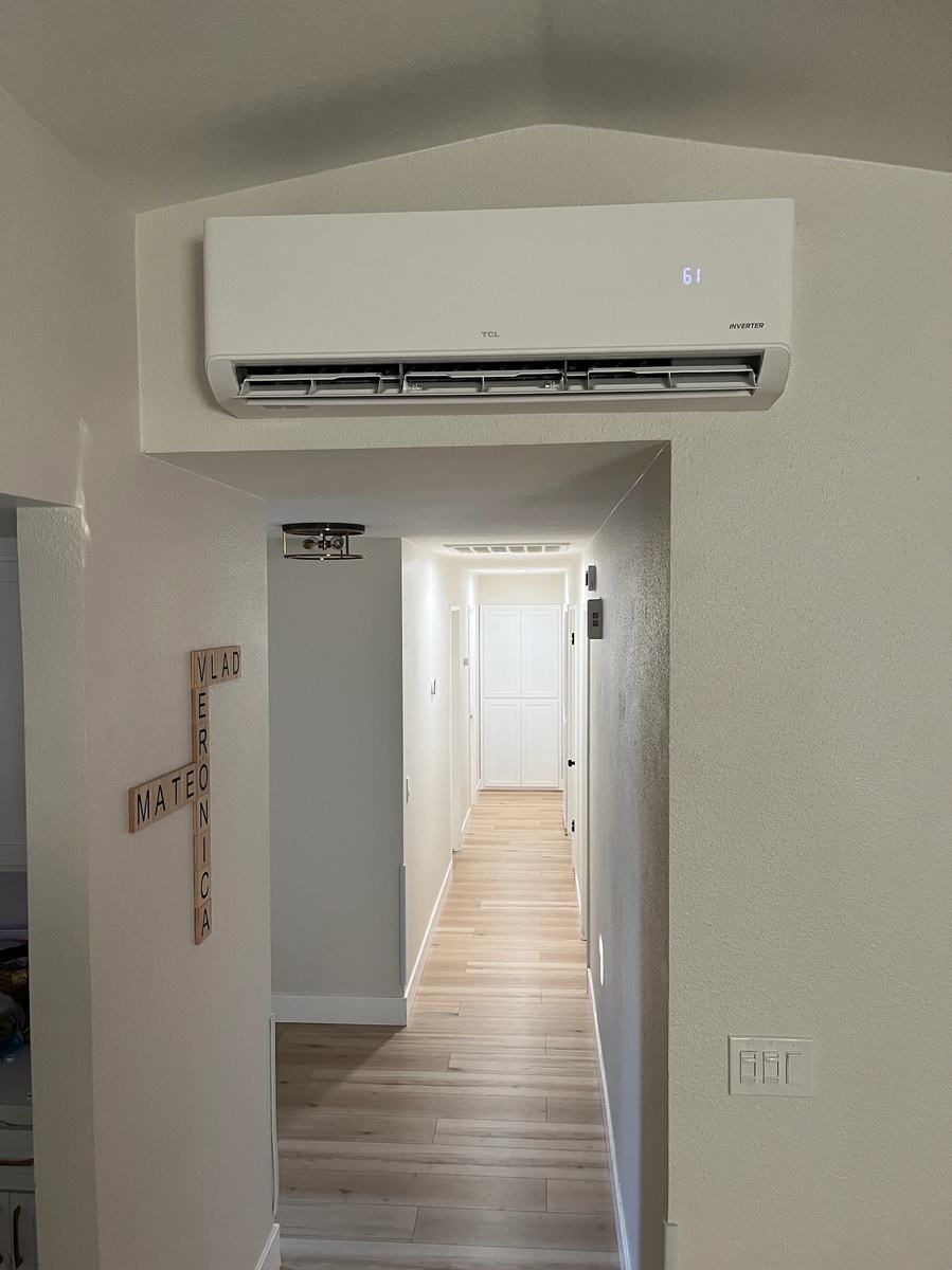 18k BTU TCL wall-mount mini-split head installed in a family room hallway