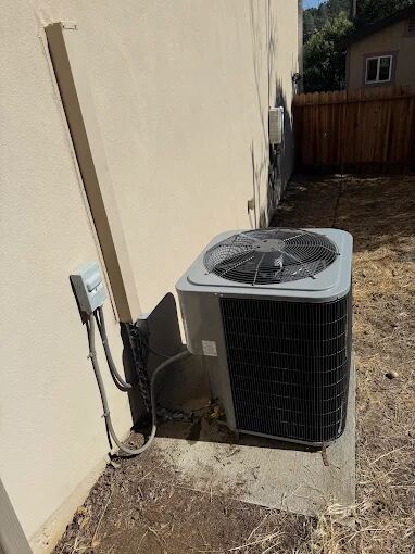 Outdoor central air conditioning condenser unit on a Sacramento home